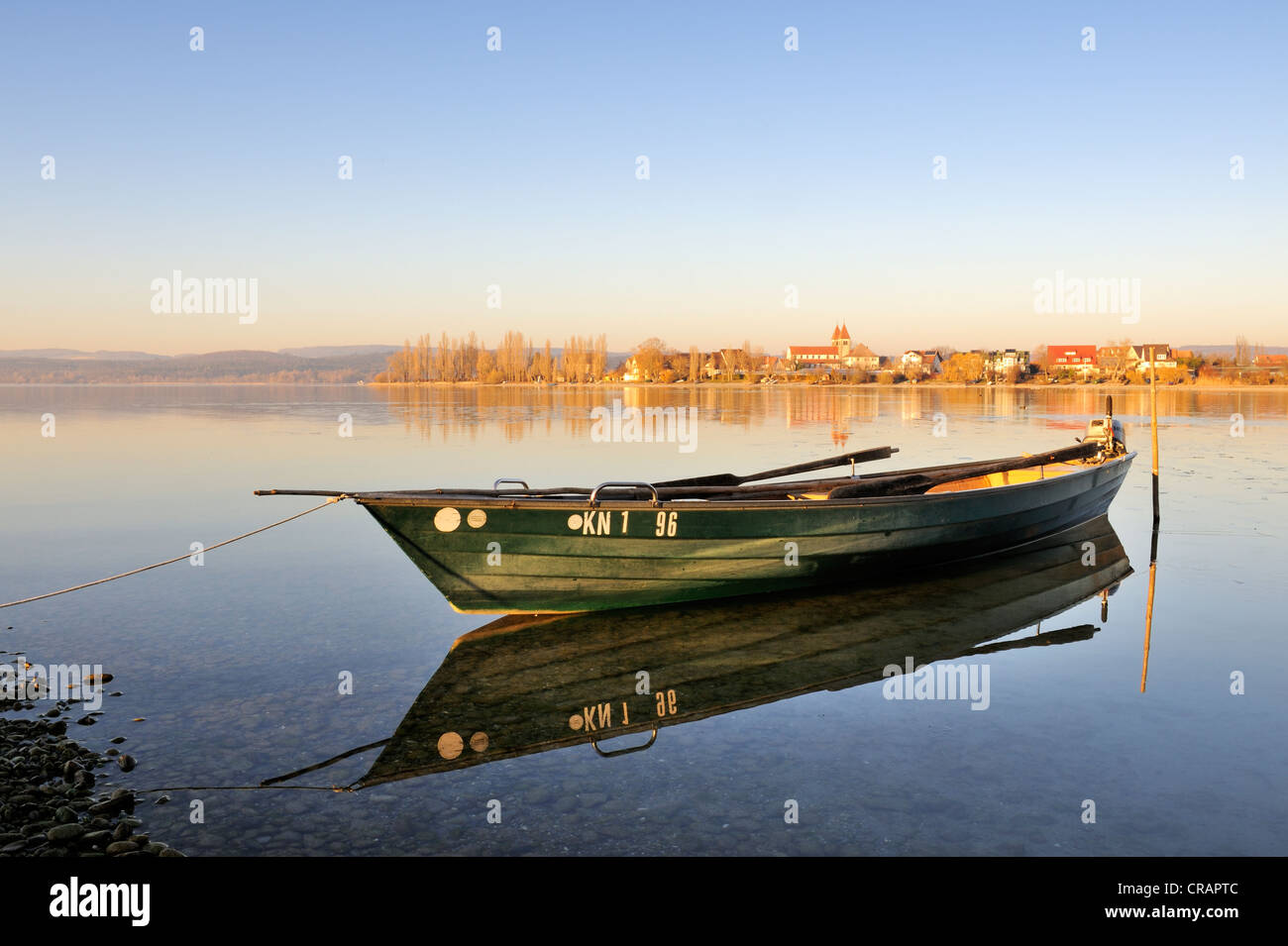 Abendstimmung mit einem Fischerboot am Ufer der Insel Reichenau, auf der Rückseite, die Kirche St. Peter und Paul auf der Stockfoto