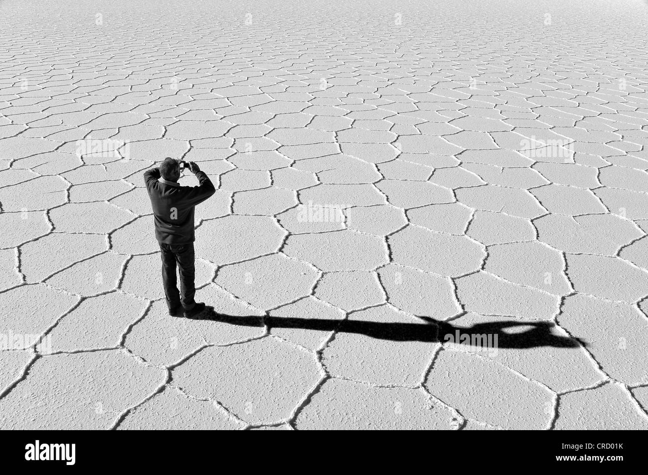 Touristische stehend auf dem Salzsee von Uyuni Salzwüste, Uyuni, Potosi, Bolivien, Südamerika Stockfoto