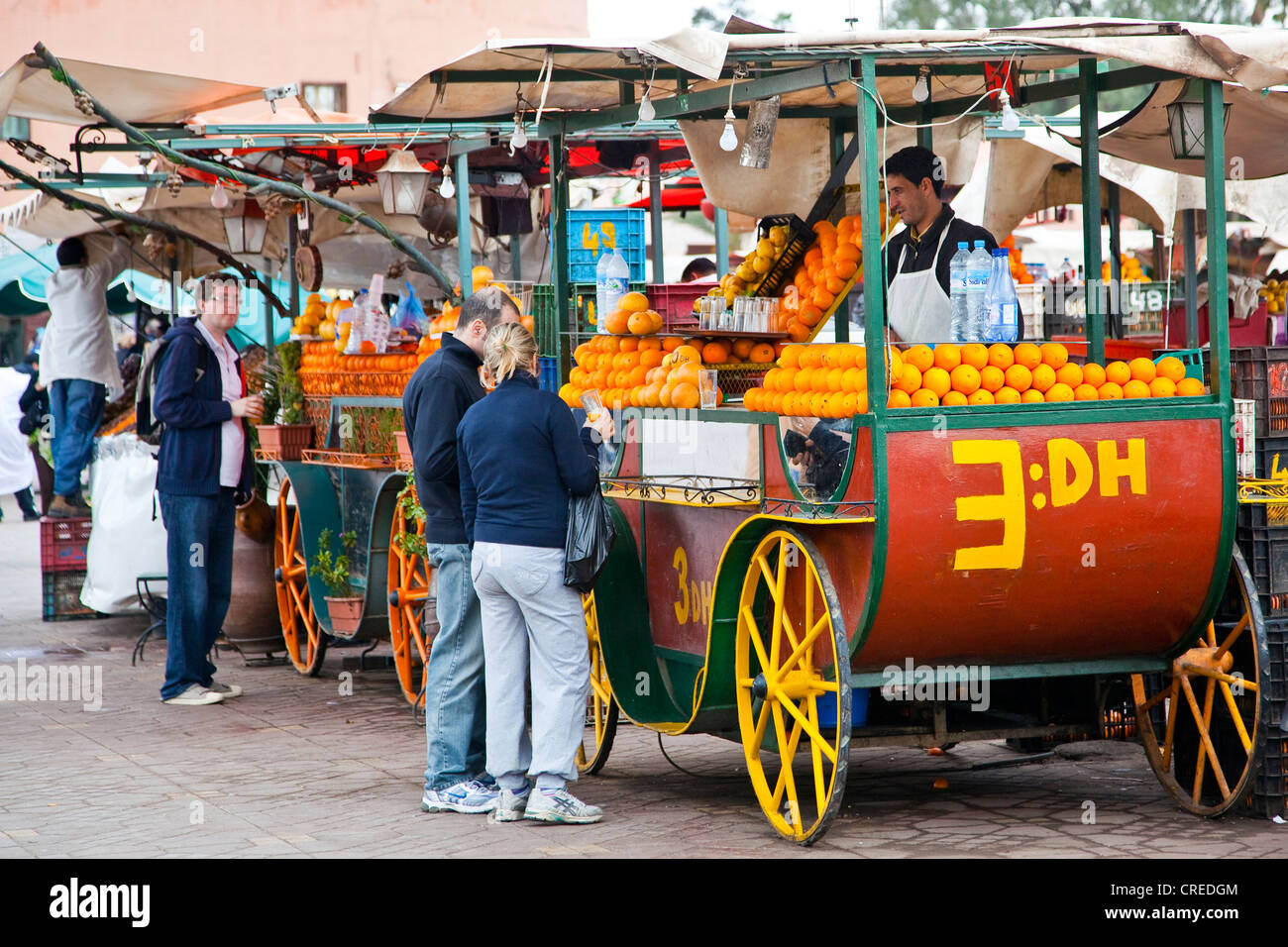 Alte Kutschen wie Marktstände für frisch gepressten Orangensaft in Platz Djemaa El Fna, Medina oder Altstadt Stockfoto