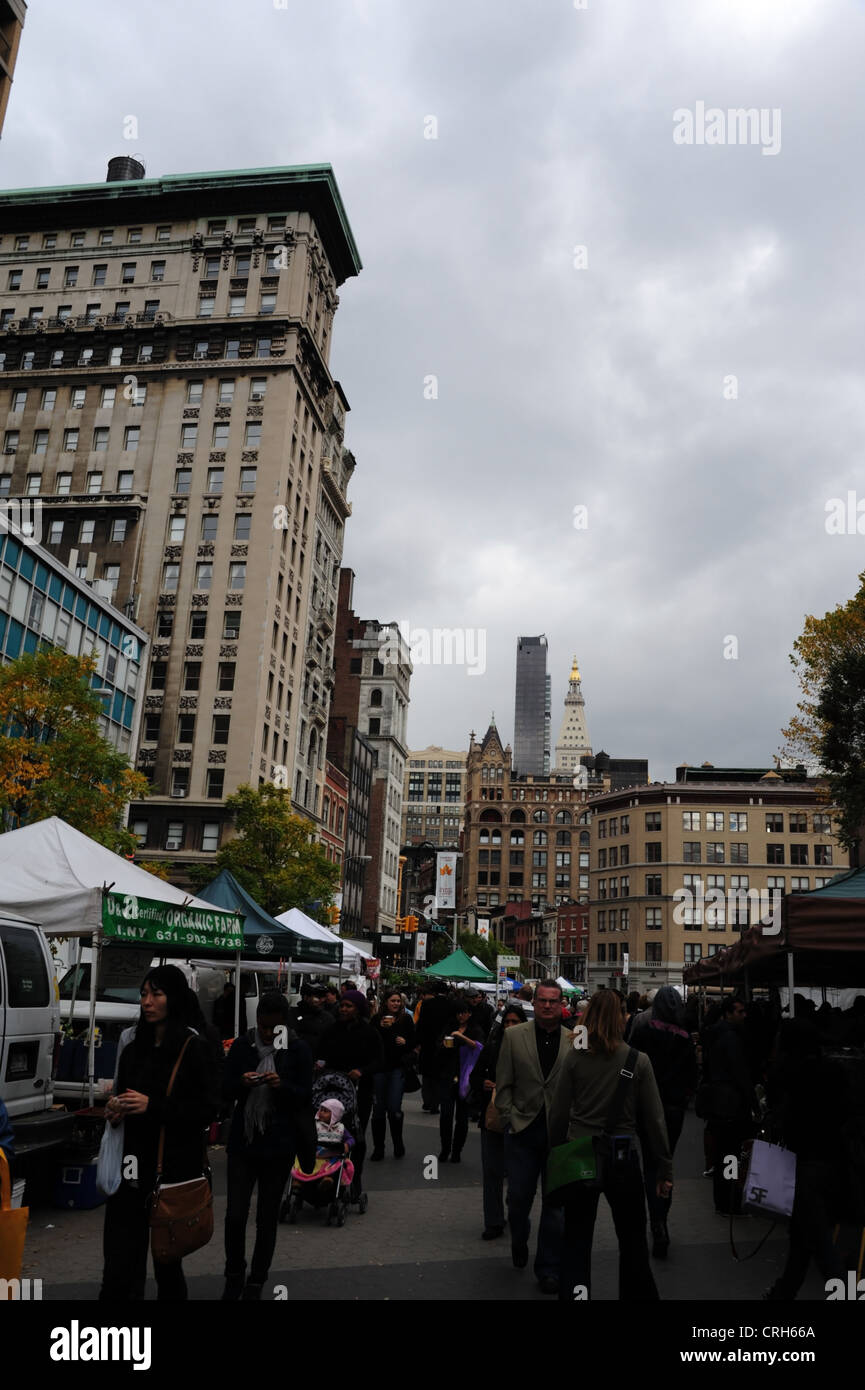 Grauen Himmel Porträt, in Richtung Decker Gebäude, viele Menschen zu Fuß vorbei an Open-Air-Stände, Union Square Greenmarket, New York Stockfoto