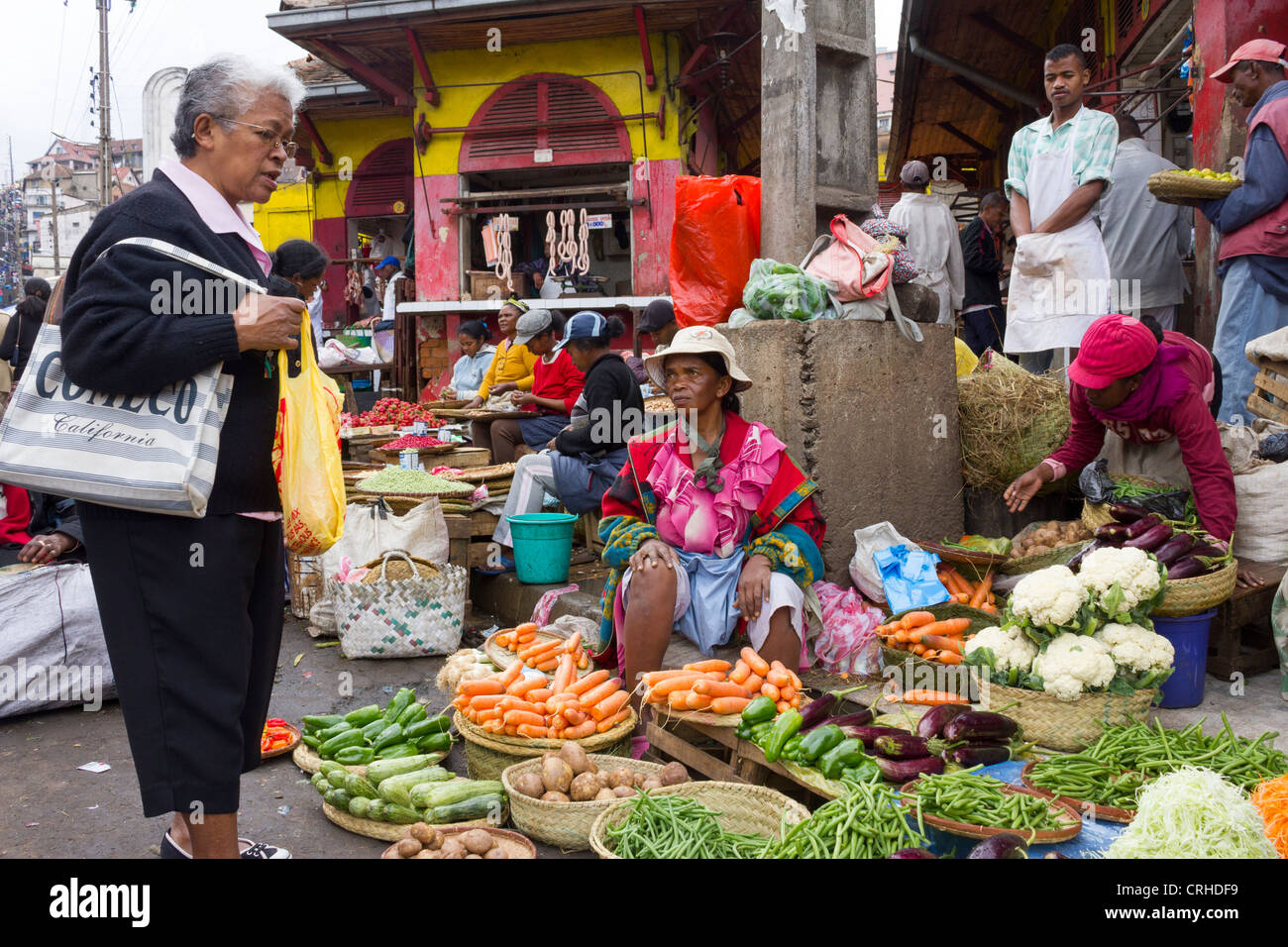 Frau kaufen Gemüse am Stall, Markt Analakely, Antananarivo, Madagaskar Stockfoto