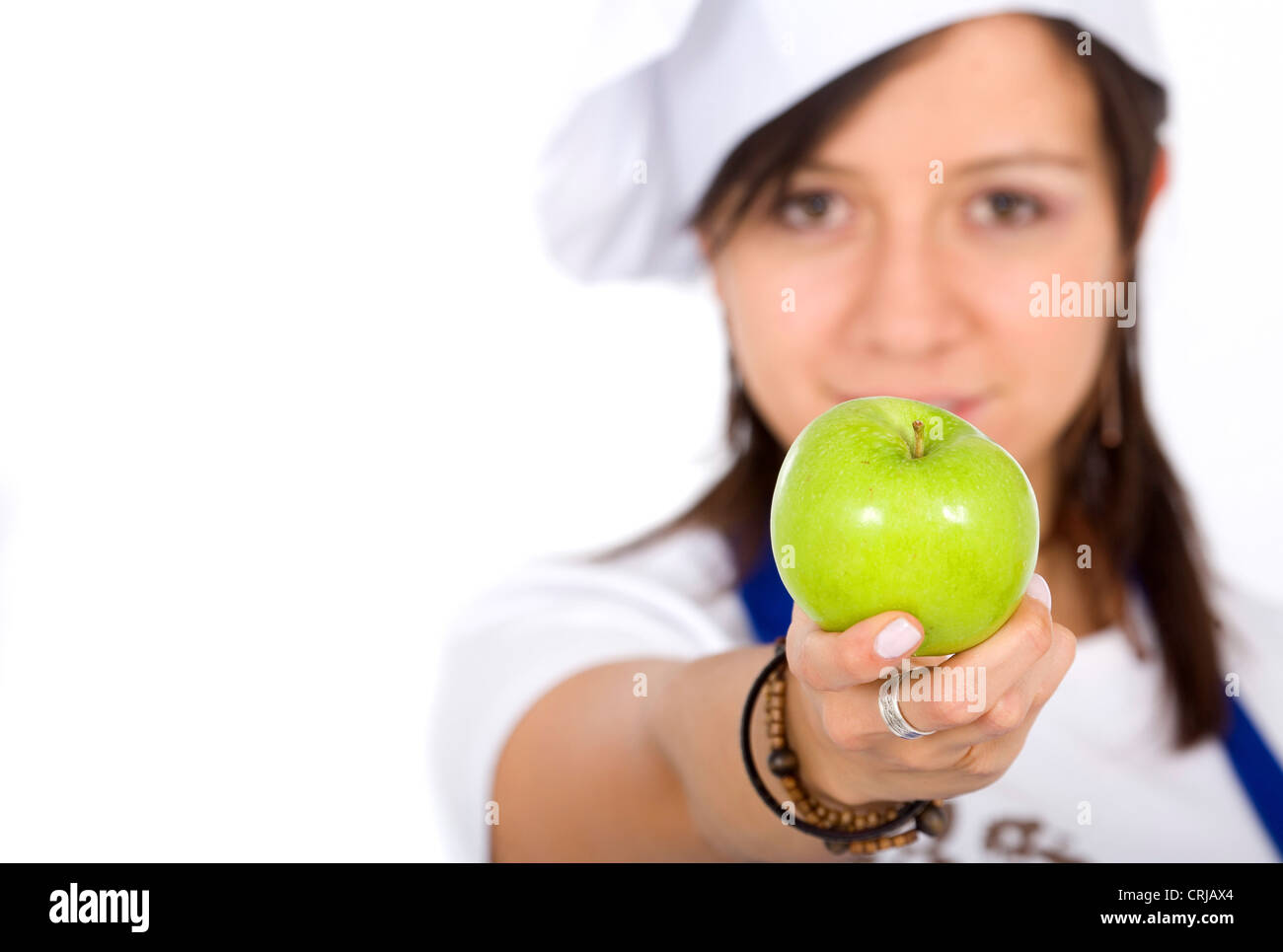 Köchin mit einem Apfel Stockfoto