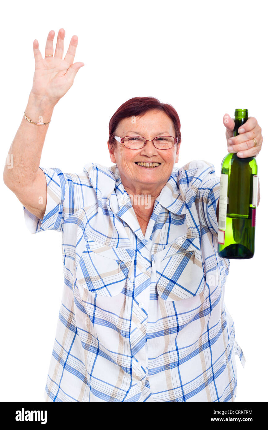 Glücklich betrunken Seniorin mit Flasche Alkohol, isoliert auf weißem Hintergrund. Stockfoto