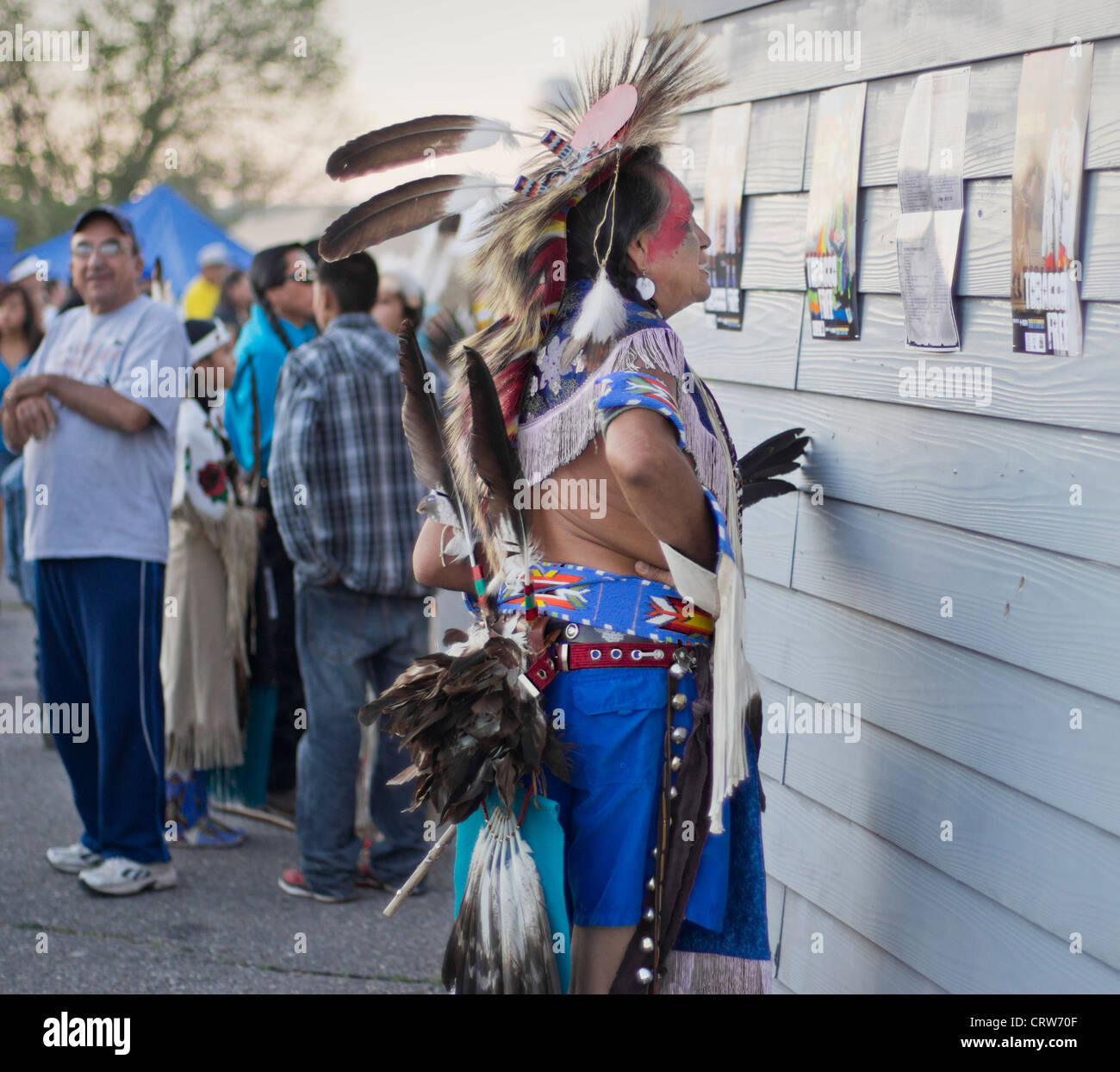 Fort Washakie, Wyoming - Mann in voller Rehalia überprüfen der Fahrplan von einem Powwow in den indischen Tagen. Stockfoto