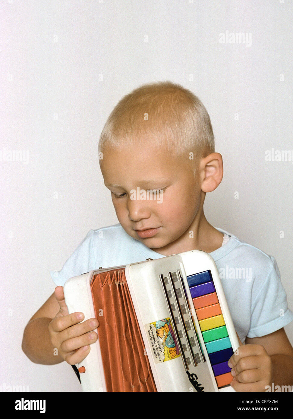 Fuenfjaehriger junge spielt auf seinem Akkordeon Stockfoto