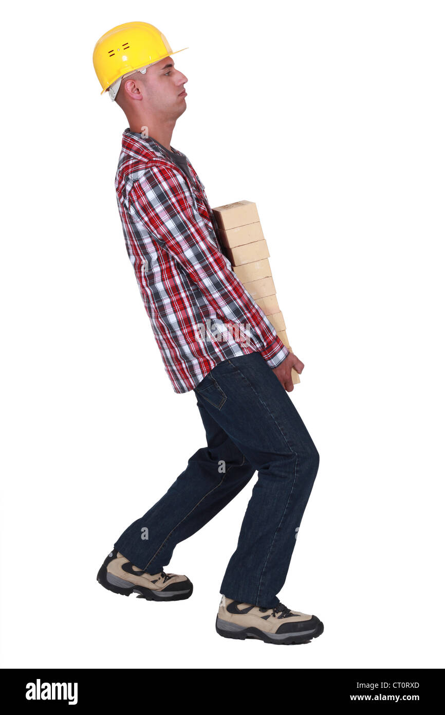 Mason mit Haufen von Steinen Stockfoto