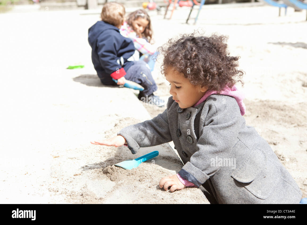 Mädchen spielen mit Sand auf Spielplatz Stockfoto