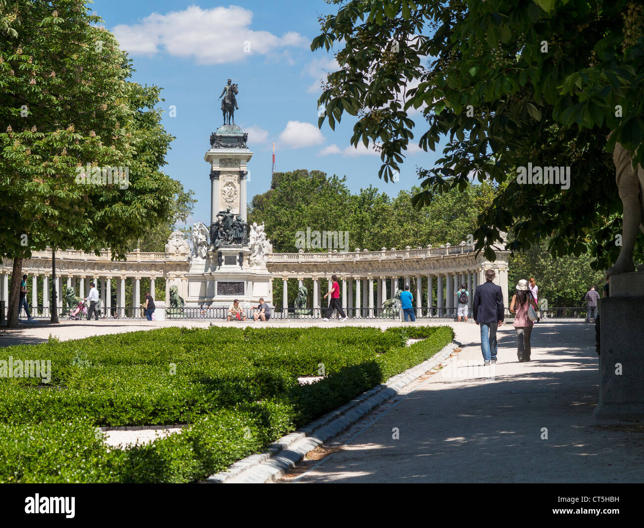 Paar zu Fuß entlang Paseo de Argentina zur Statue des Königs Alfonso XII im Parque del Retiro, Madrid Stockfoto