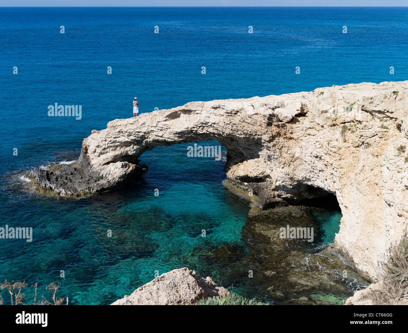 dh Griechenland Insel AYIA NAPA SÜDZYPERN Russischer Tourist Mann auf Meeresbogen klares blaues Meer Küstenfelsen Höhlenmenschen Stockfoto