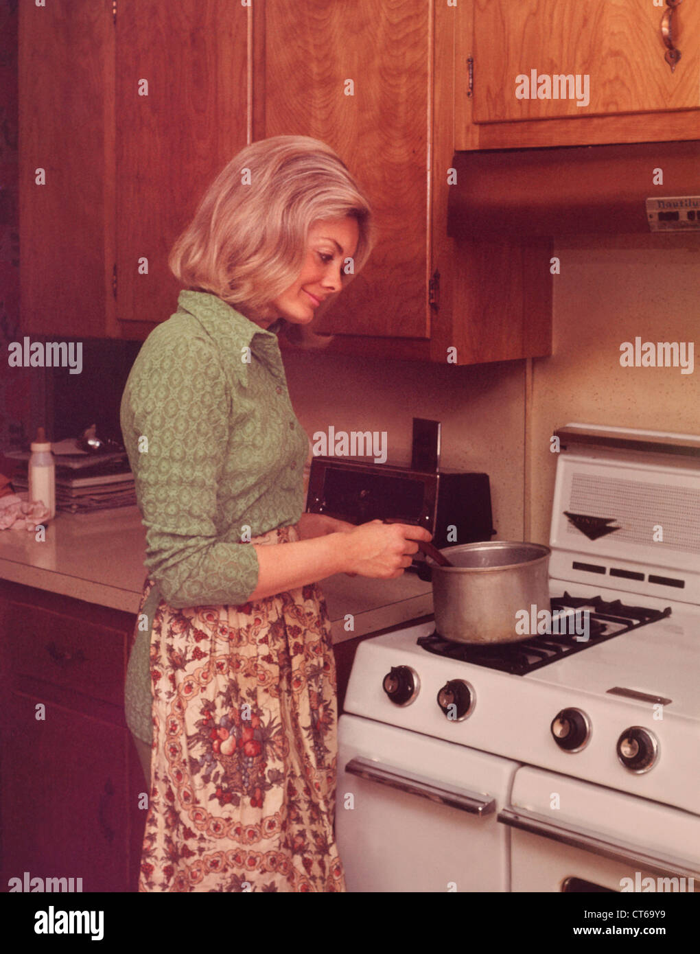 Frau, die Zubereitung von Speisen in der Küche der 1970er Jahre nach Hause Stockfoto