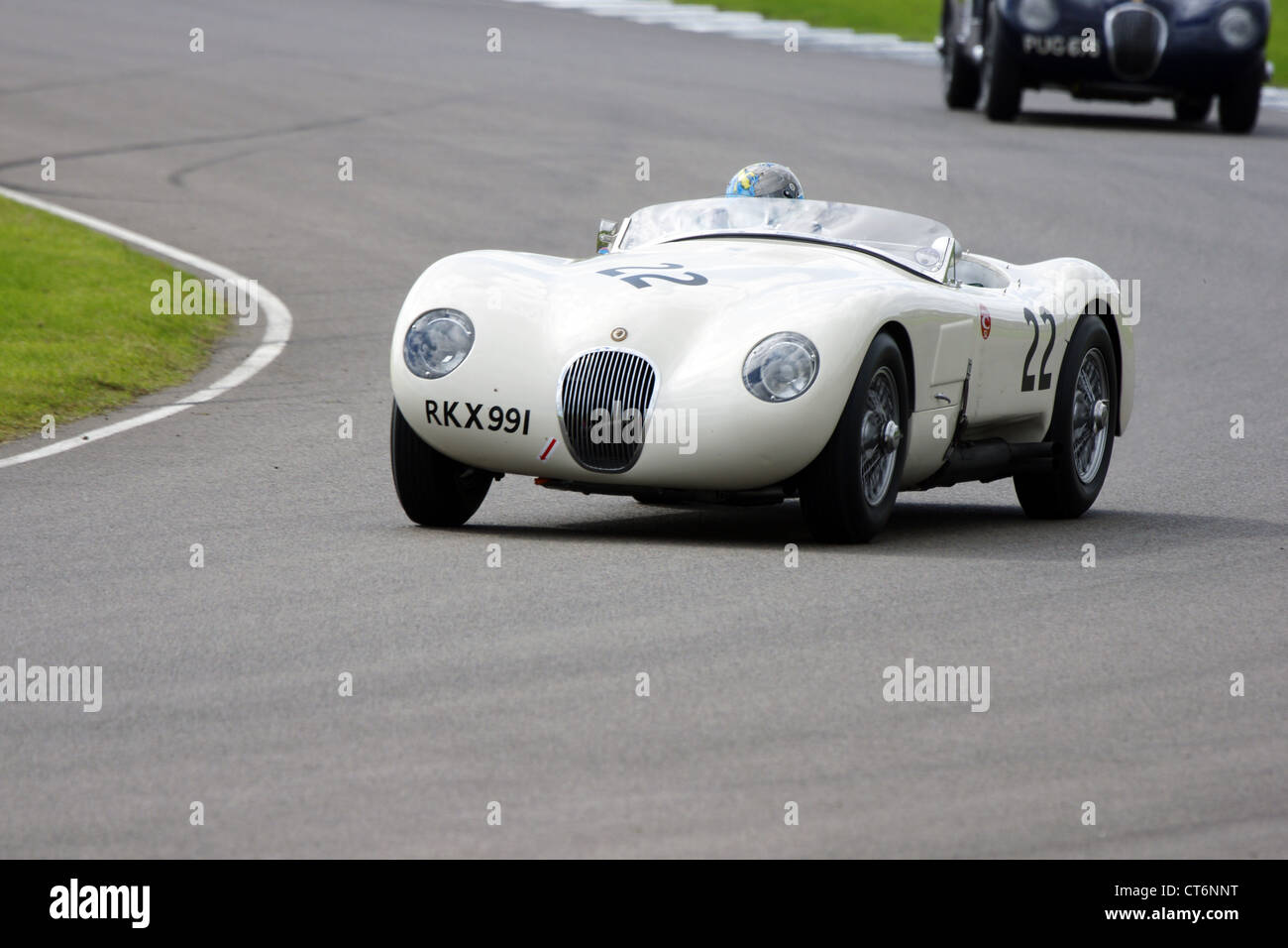 C-Type Jaguar Kurvenfahrt hart beim Goodwood Revival Stockfoto