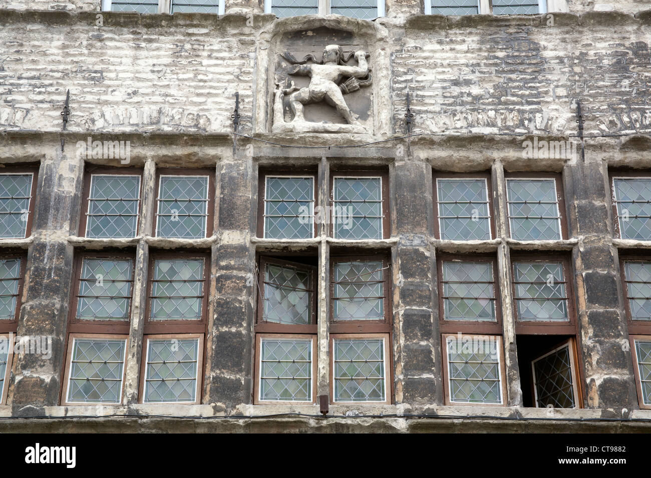 Mittelalterliche Gebäude front mit Bleiglasfenster und Stein männliche Figur Gent Belgien Stockfoto