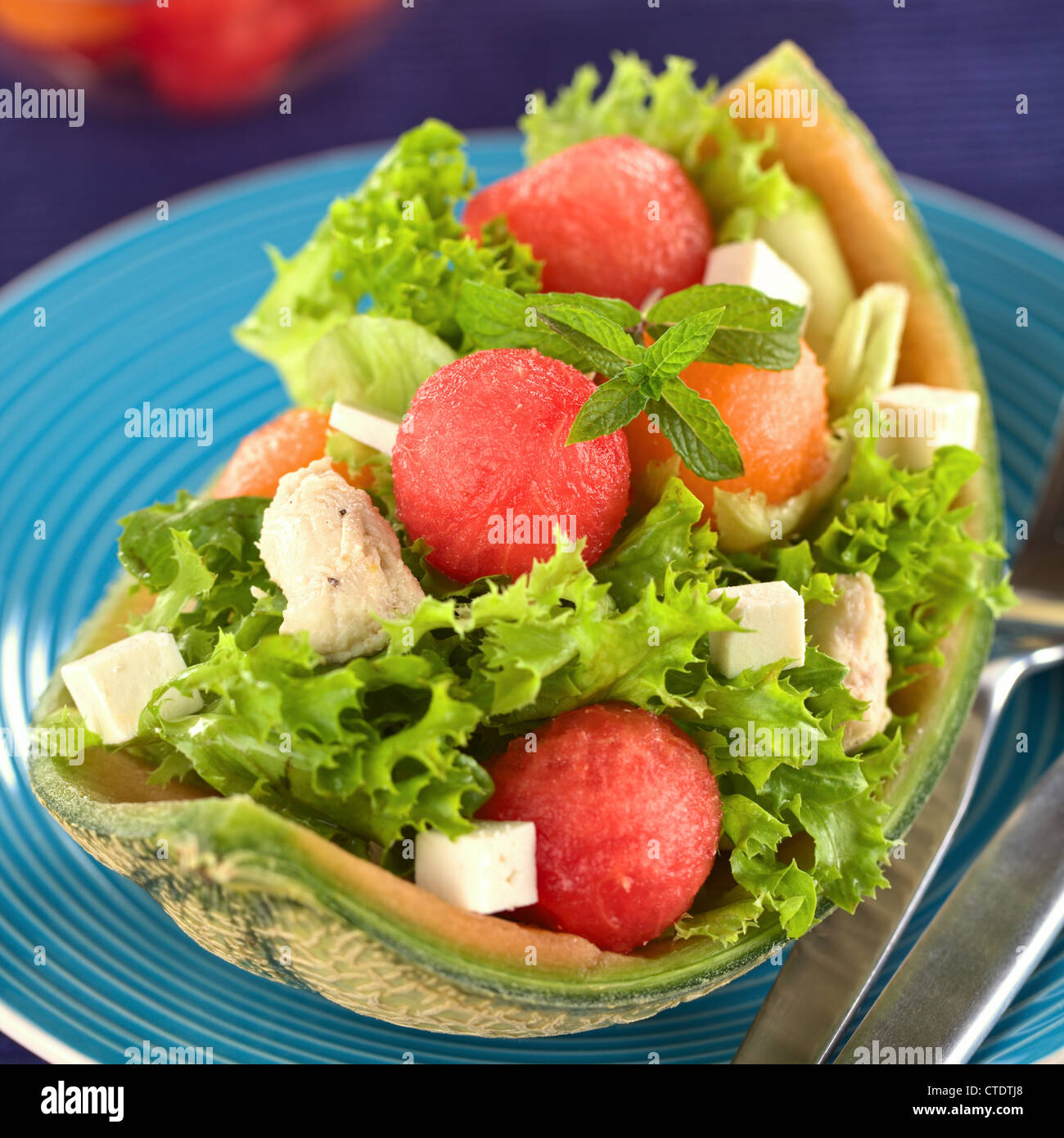 Frischer Salat aus Wassermelone, Melone Melone, Huhn, Gurken, Käse und Salat Stockfoto