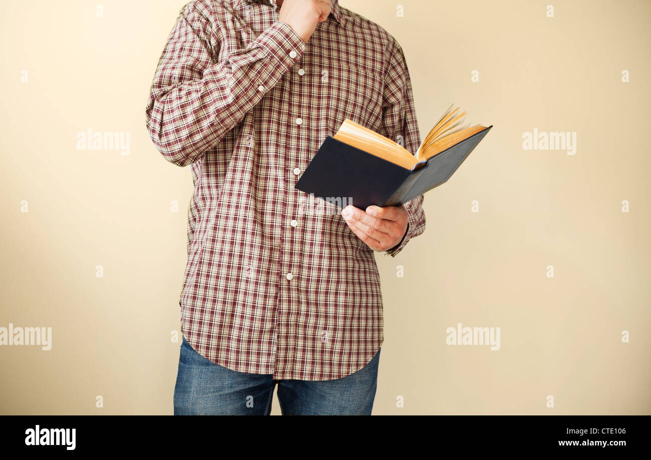 Mann in braun kariertes Hemd, ein Buch zu lesen Stockfoto