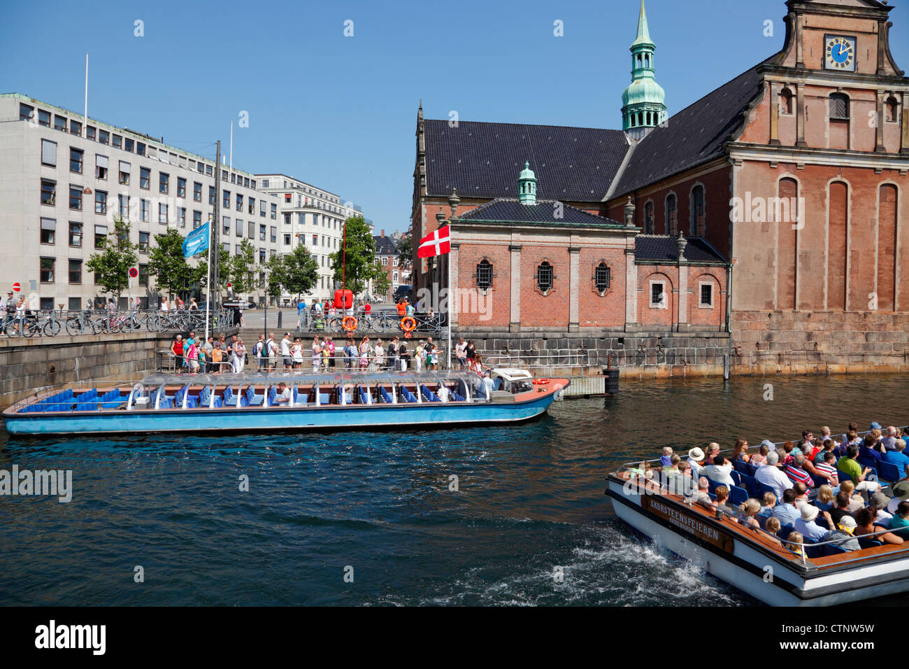 Eine Grachtenfahrt Boot erfüllt und voller Passagiere der Holmens Kirche in der Slotholmskanalen vorbei. Stockfoto