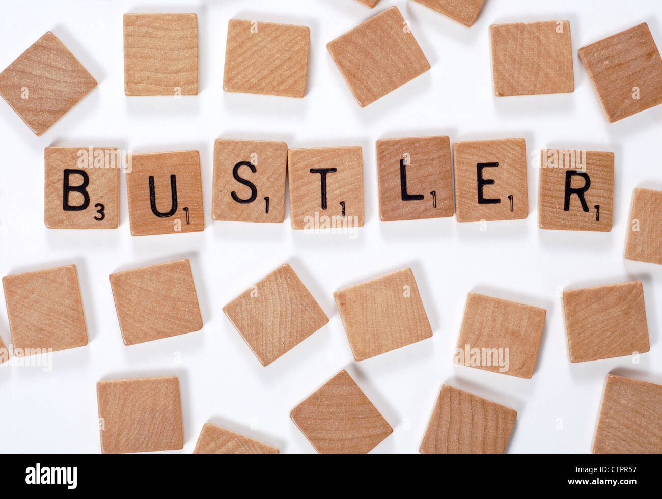 Neues Wort aus einem Wörterbuch: Bustler, ausgeschrieben mit Holzfliesen Stockfoto