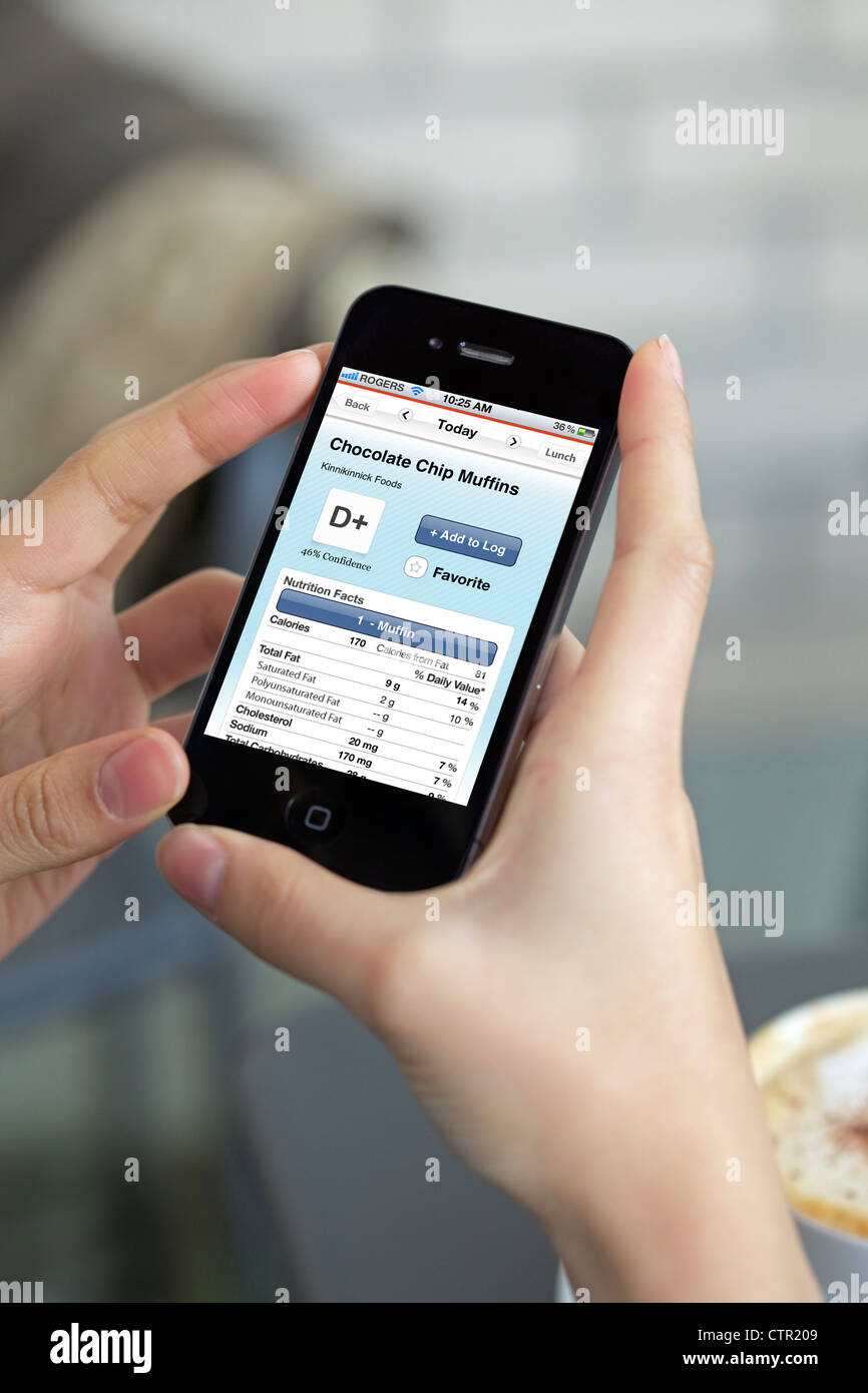 Gesundheit bewusst weibliche Überprüfung Essen Kalorien mit Kalorien-Zähler-app  auf ihrem Iphone 4 Stockfotografie - Alamy