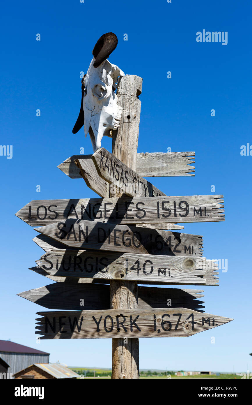 Wegweiser zeigen Entfernungen zu größeren Städten der USA in "1880 Town" westlichen Attraktion in Murdo, South Dakota, USA Stockfoto