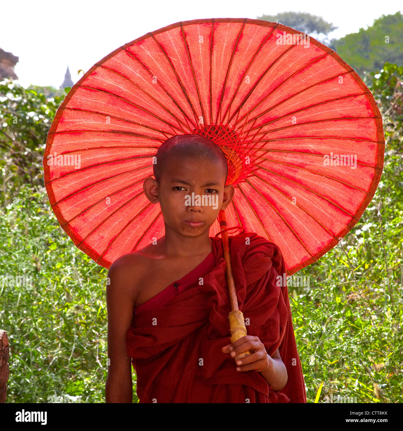 Myanmar, Burma. Bagan. Junge Novize und Sonnenschirm. Stockfoto