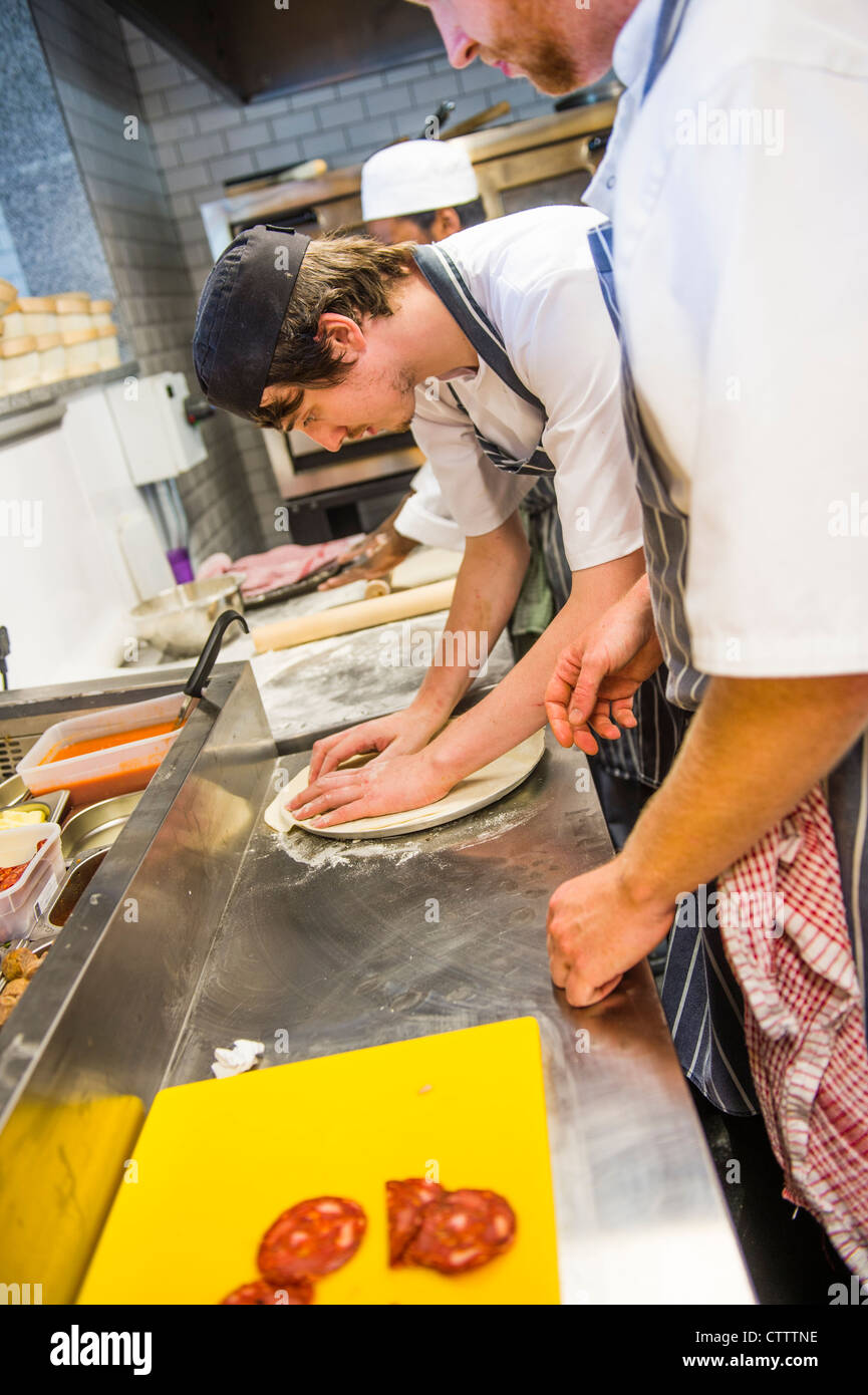 Ein Koch bereitet eine Pizza in BARAVIN, eine neue Pizzeria Café bar Bistrorestaurant in Aberystwyth, Wales, UK Stockfoto