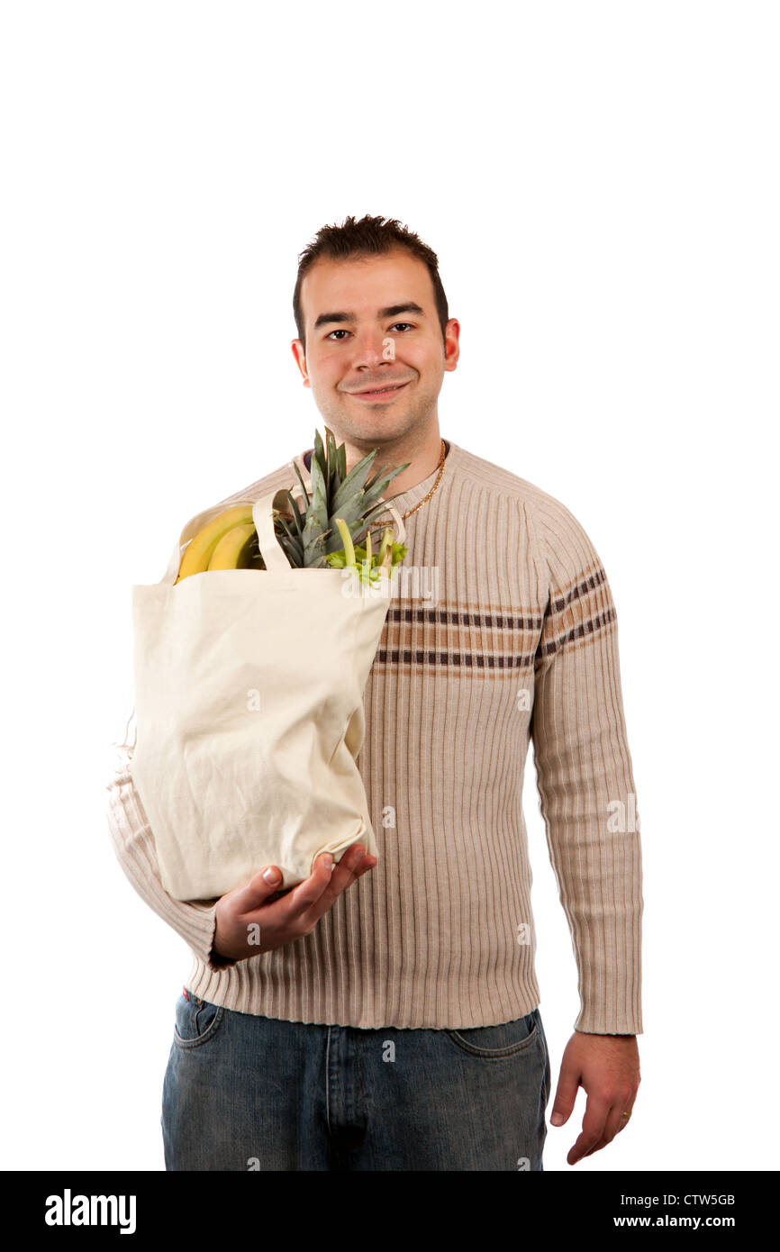 Weiße männliche Lebensmittel Shopper lächelnd halten Sie eine Tasche voller Frische Lebensmittel. Stockfoto