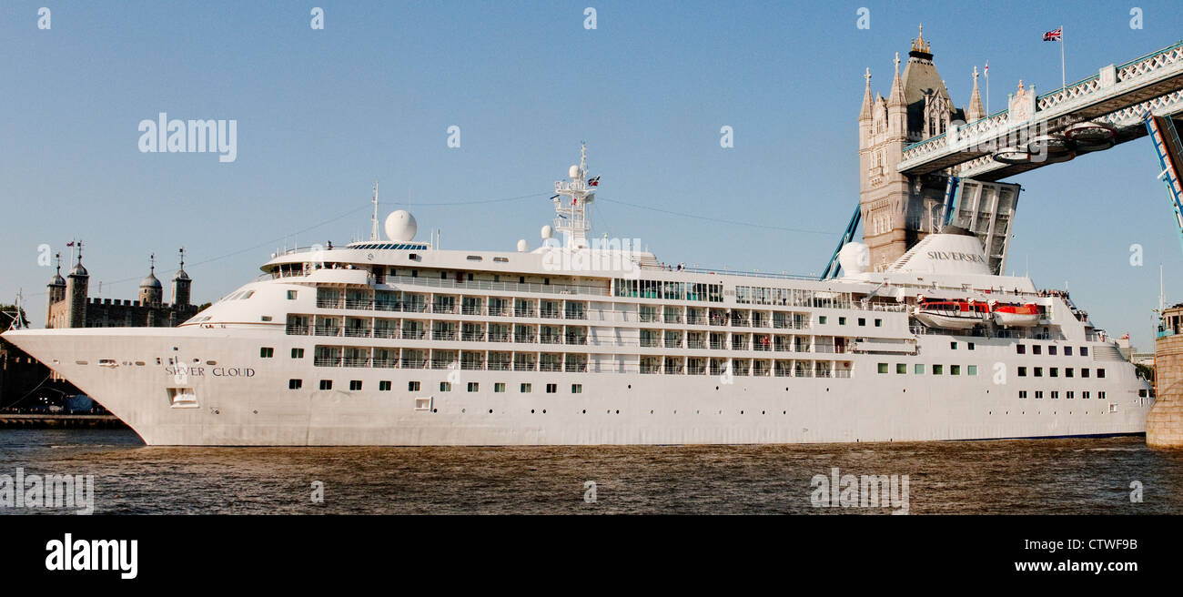 Der Silver Cloud Kreuzfahrtschiff unterquert die Tower Bridge mit Hilfe von einem Schlepper an einem hellen Sommertag Stockfoto