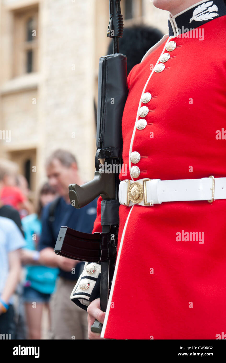 Nahaufnahme der traditionellen roten Uniform und des Gewehr der Royal Scots Guard. Tower of London UK Stockfoto