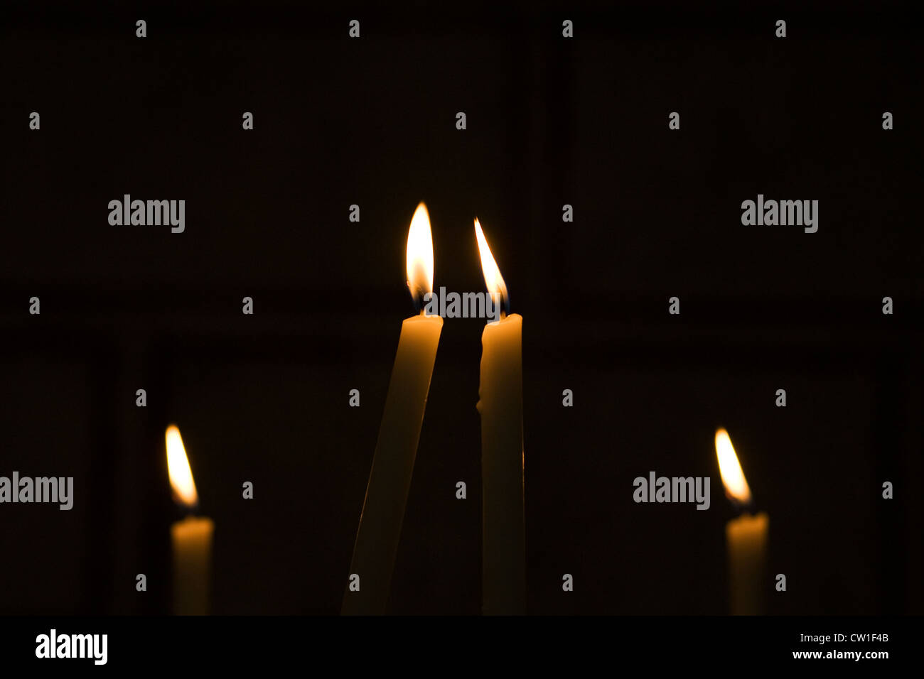 Vier Kerzen in der Dunkelheit. Stockfoto