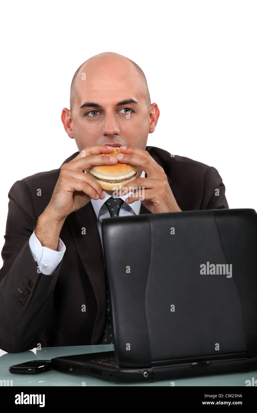 Geschäftsmann, einen Hamburger Essen Stockfoto