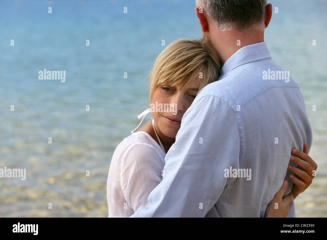 blonde Frau, ihr Mann umarmt Stockfoto