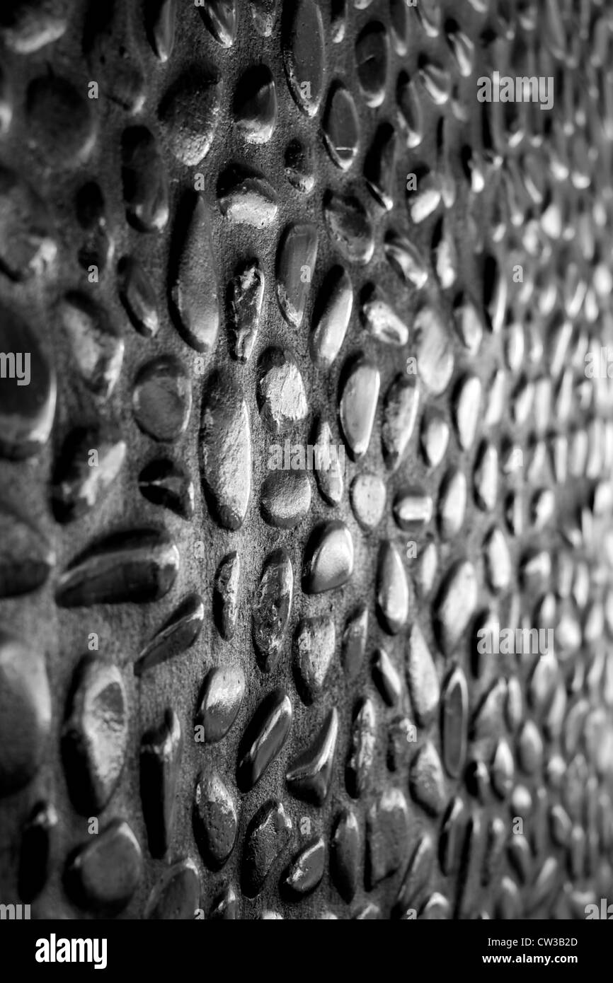 Innenwand aus glänzend schwarze Kieselsteine in Beton gegossen. Blick von bei niedrigen Winkel nach links. Wählen Sie konzentrieren. Schwarz-weiß Foto. Stockfoto