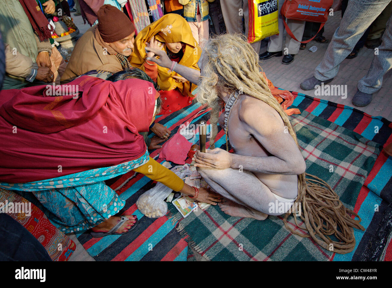 Sadhu (Heiliger) Segen Pilger auf der Straße während Kumbh Mela Festival 2010, Haridwar, Indien. Stockfoto