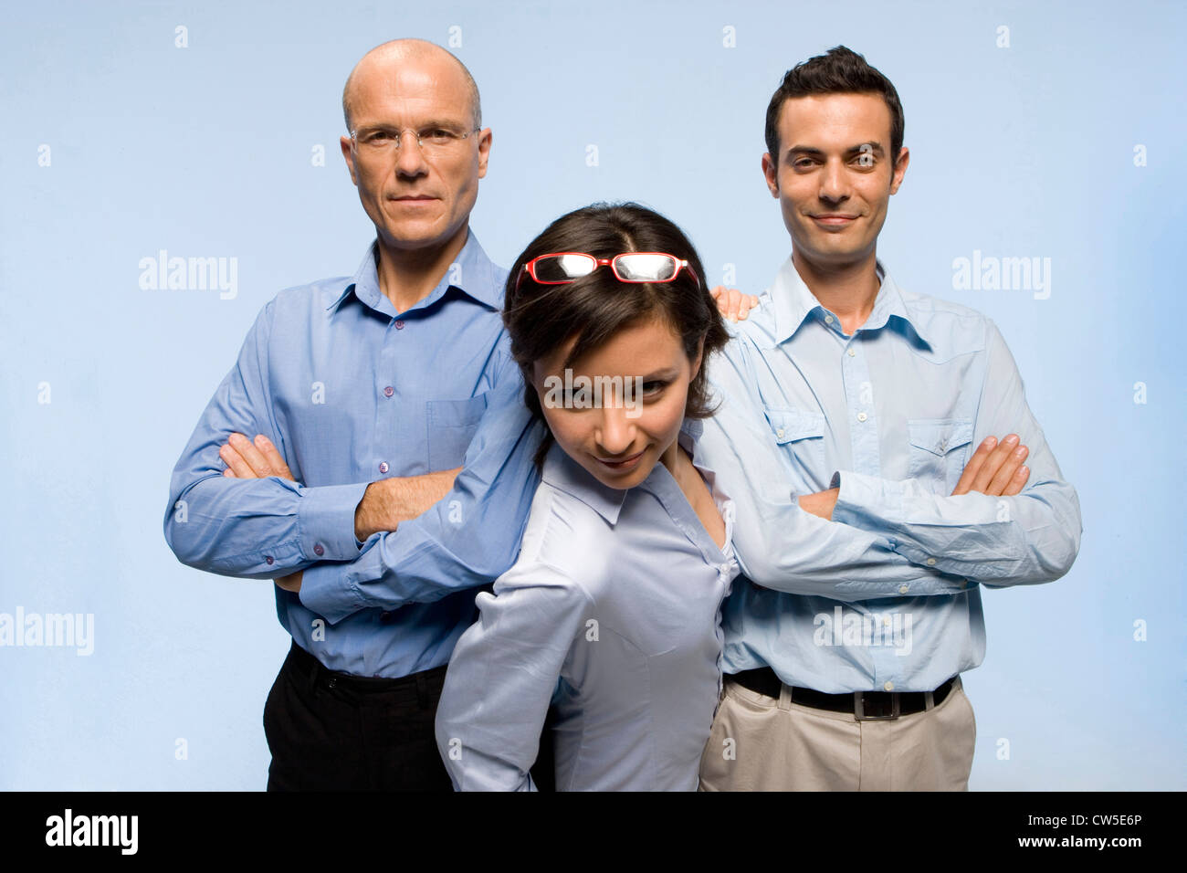 Geschäftsfrau, die ihren Weg zwischen zwei Geschäftsleute drücken Stockfoto