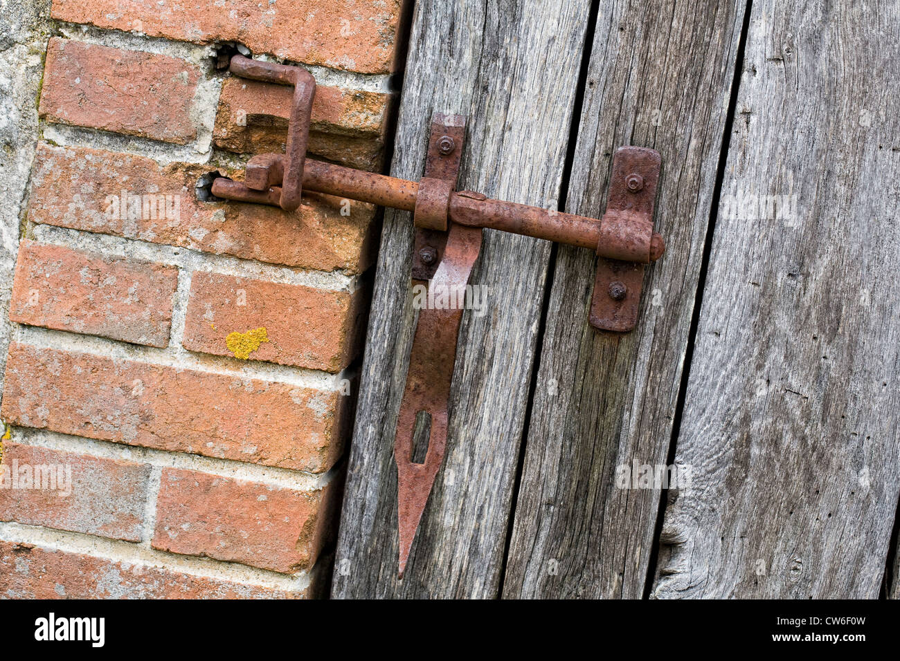 Rostige Sperre für ein Tor zu einer französischen Nebengebäude. Stockfoto