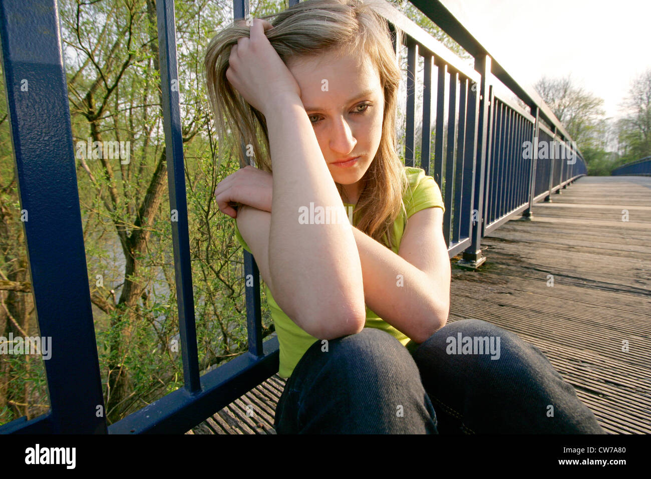 Teenager-Mädchen sitzen auf Brücke, gedankenverloren, Deutschland, Ruhrgebiet, Herdecke Stockfoto