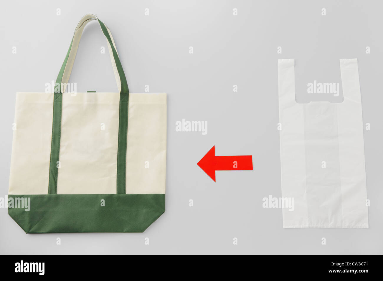 Roter Pfeil-Zeichen zwischen Shopping Bag und Plastiktüte Stockfoto
