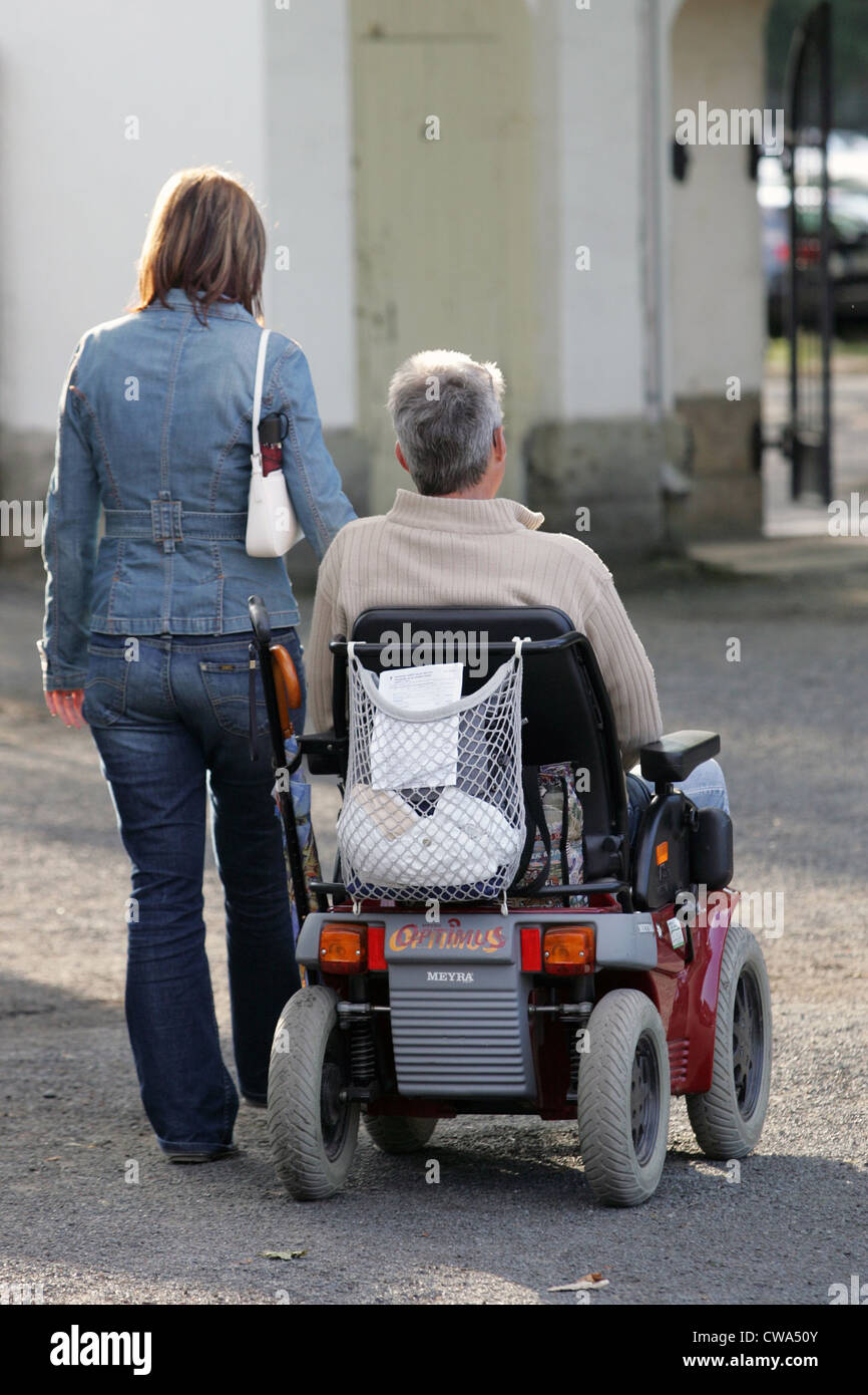 Dresden, eine Frau, begleitet von einem Rentner im Rollstuhl Stockfoto