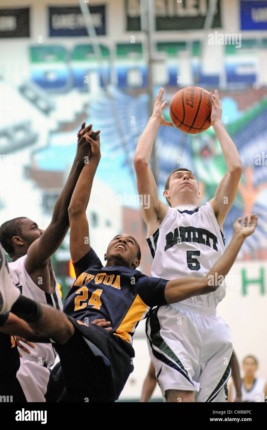 Basketball Spieler kämpfen für den Besitz einer Erholung bei einem High School Spiel. USA. Stockfoto