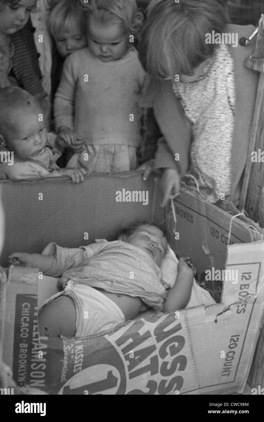 Babys in einem Pappkarton Krippe am Kern California Migranten camp Pre-School während Mutter in den Bereichen arbeitet. Foto: November 1936 Stockfoto