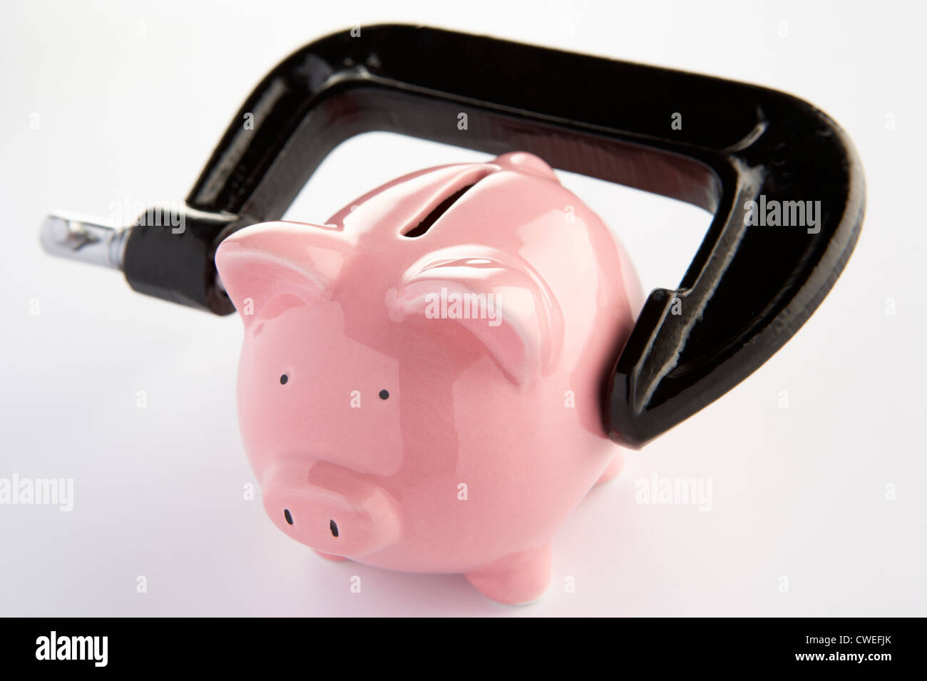 Sparschwein in einen Schraubstock Stockfoto