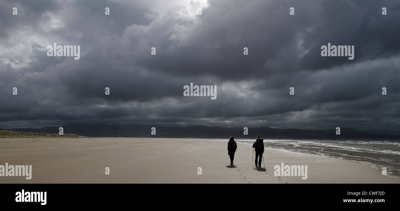 zwei Figuren Fuß am Strand entlang Stockfoto