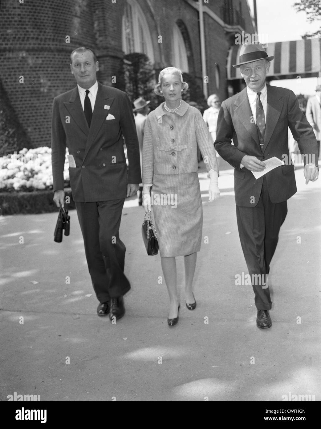 Winston F.C. Guest und seine Frau C.Z Gast, mit einem unbekannten Mann zu Fuß bei der Saratoga Race Course, Saratoga, NY ca 1958 Stockfoto