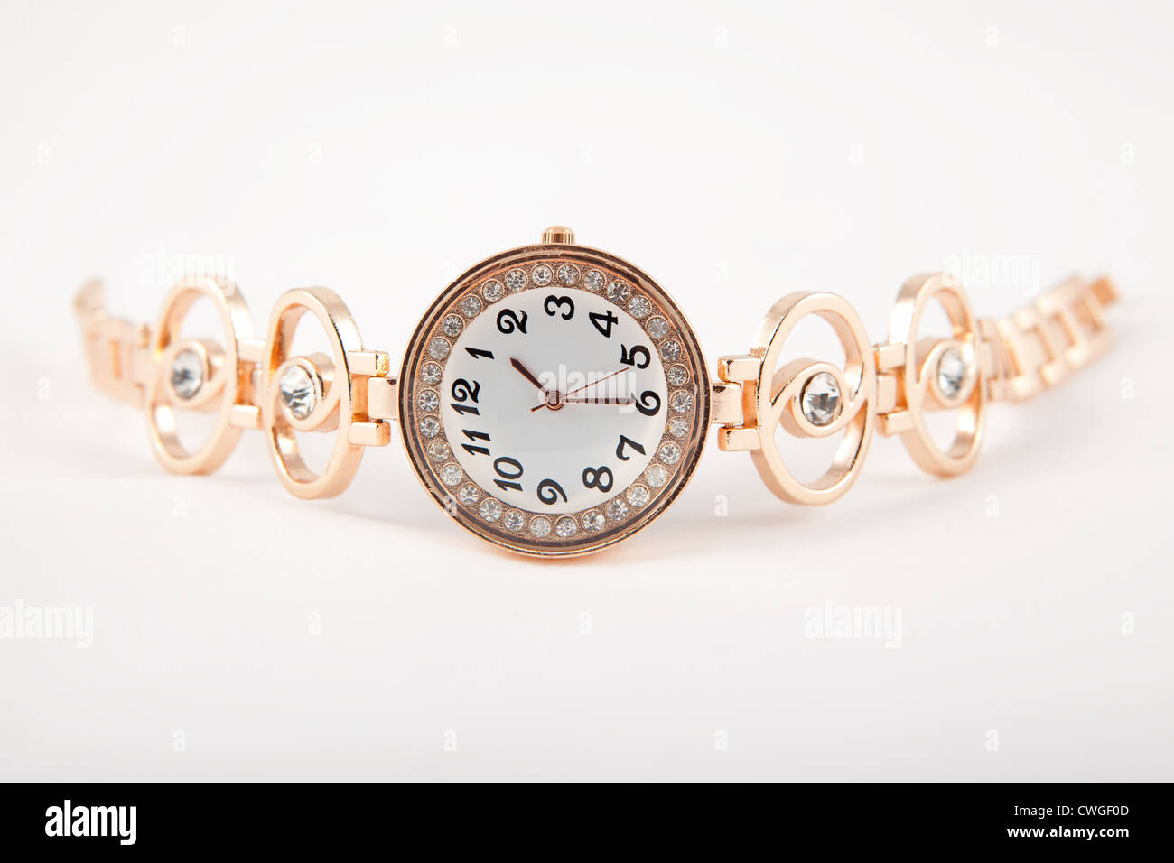 Weibliche Armbanduhr Gold auf weißem Hintergrund Stockfoto