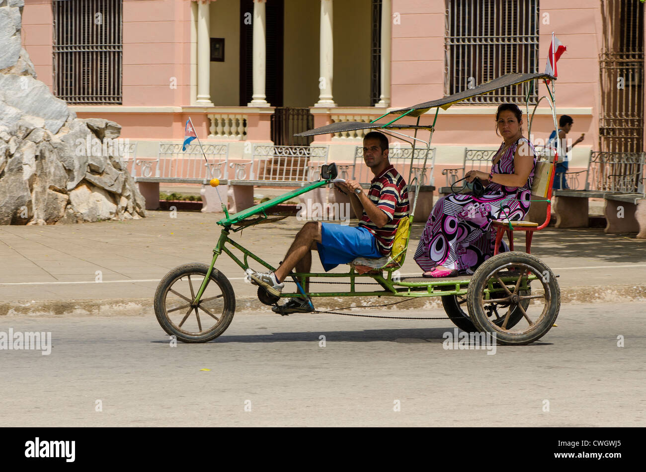 Leute Reiten in Dreirad taxi in Remedios, Kuba. Stockfoto