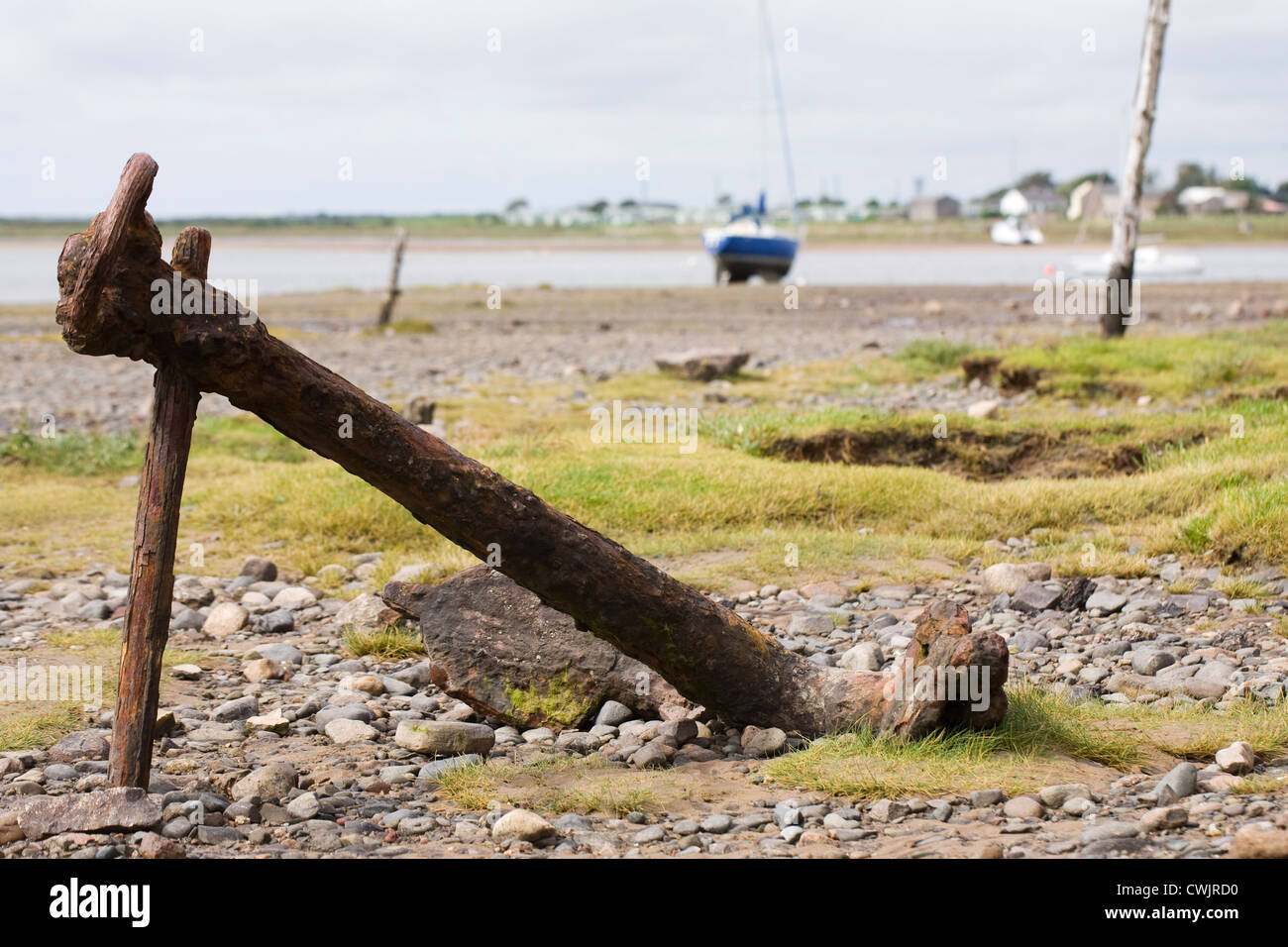 Alten rostigen Anker auf einem britischen Strand. Stockfoto