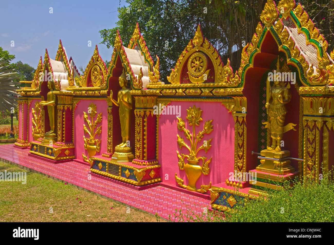 Buddhas dekoriert hoch in Pink und Gold im Wat Nai Tong Garten, Phuket Stockfoto