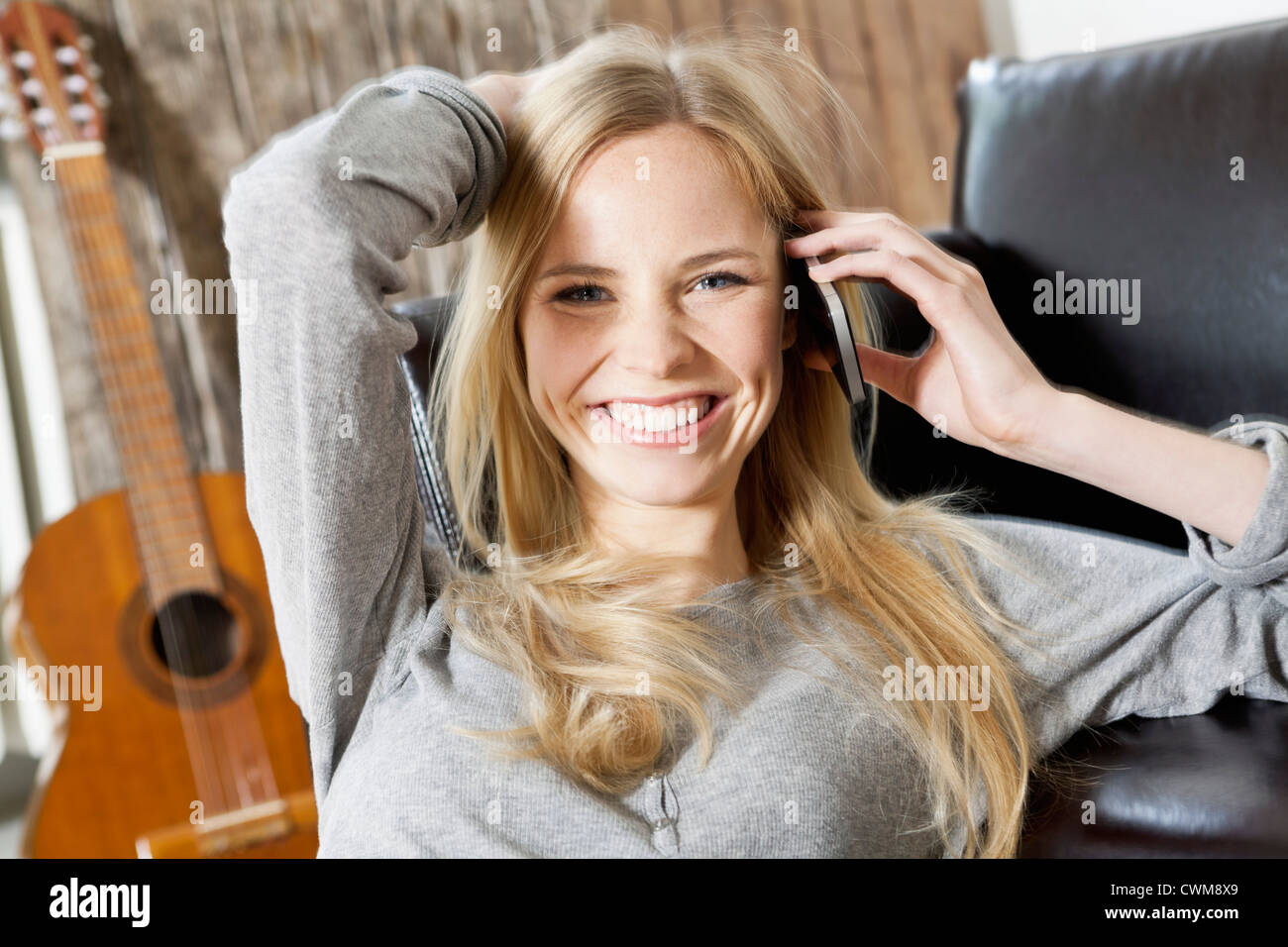 Junge Frau am Telefon, Lächeln, Porträt Stockfoto