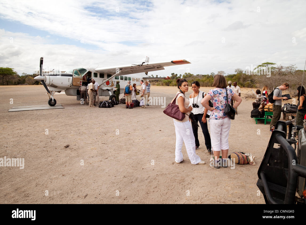 Touristen, die für Safari Urlaub von Coastal Airways im Selous Spiel reservieren Landebahn, Tansania Afrika Stockfoto