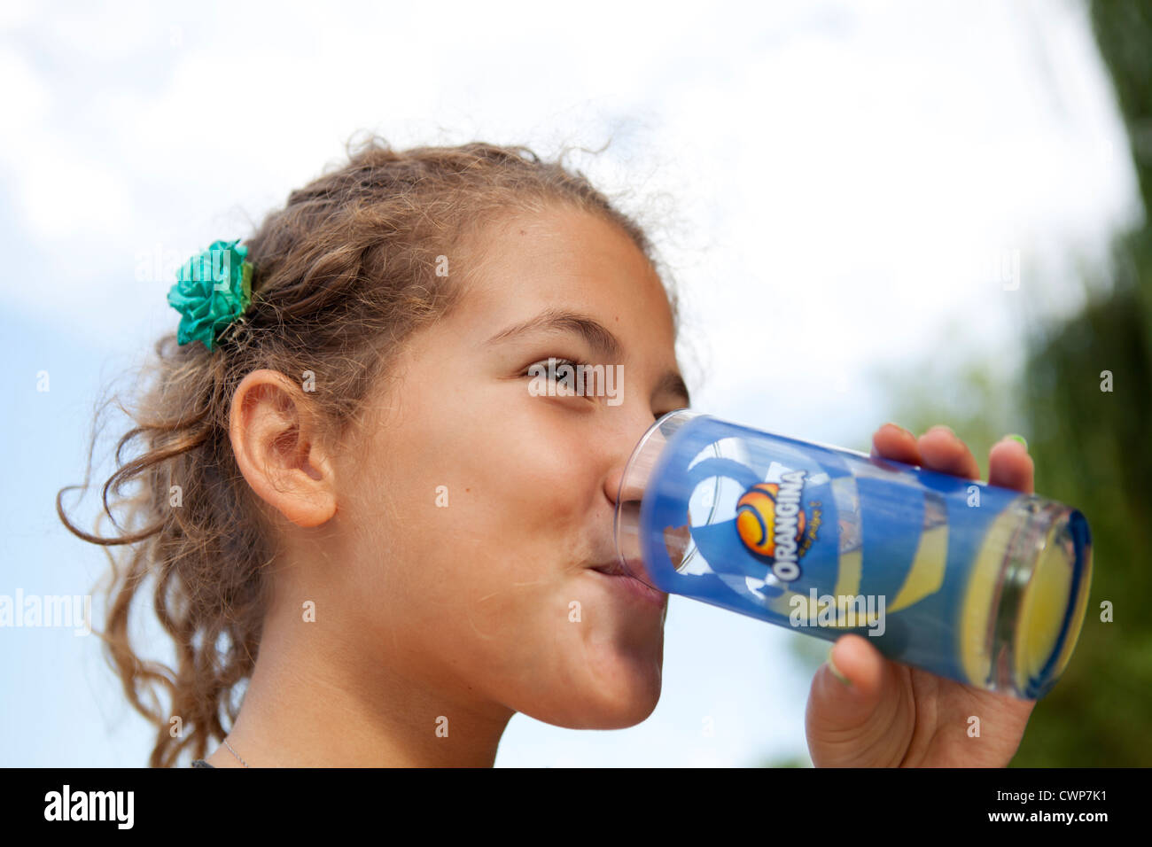 Junges Mädchen trinken französische orange Getränk namens Orangina Stockfoto