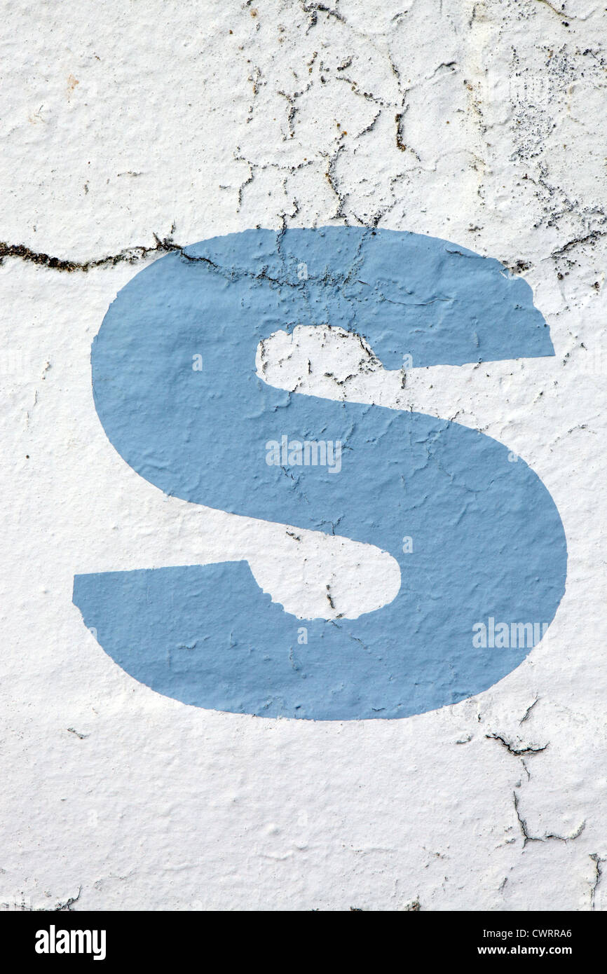 Kleinbuchstabe "s'in himmelblaue Farbe Schablonen auf bröckelt Außenwand, UK. Für andere Buchstaben siehe Nick Sinclair folio Stockfoto